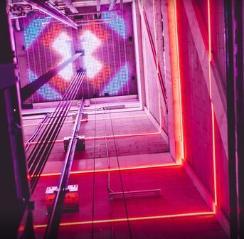 DYNLED dynamische RGB glazen schachtverlichting vanaf 5 meter, 2 vaste lichtslangen in de schacht lopen mee met de richting vd lift.